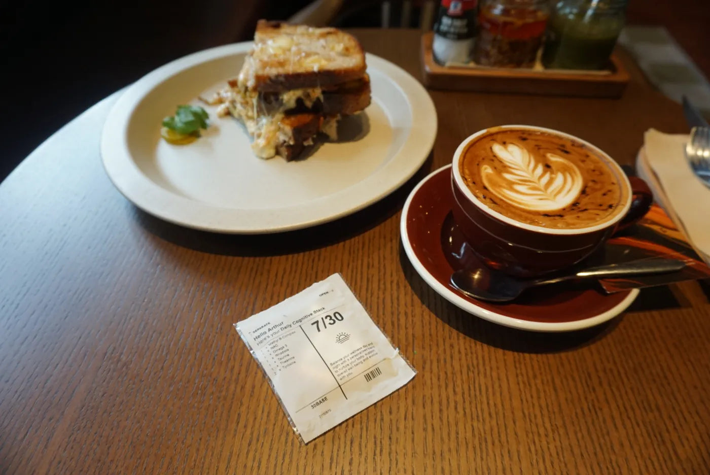 A 30BASE sachet on a cafe table next to a cup of coffee.