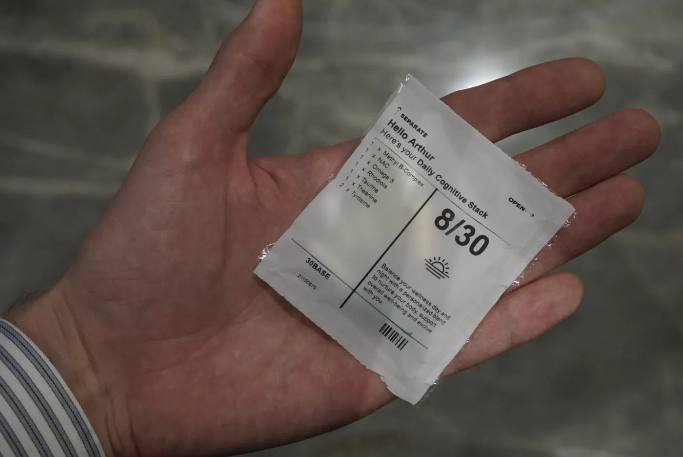 A single 30BASE daily sachet held in hand.