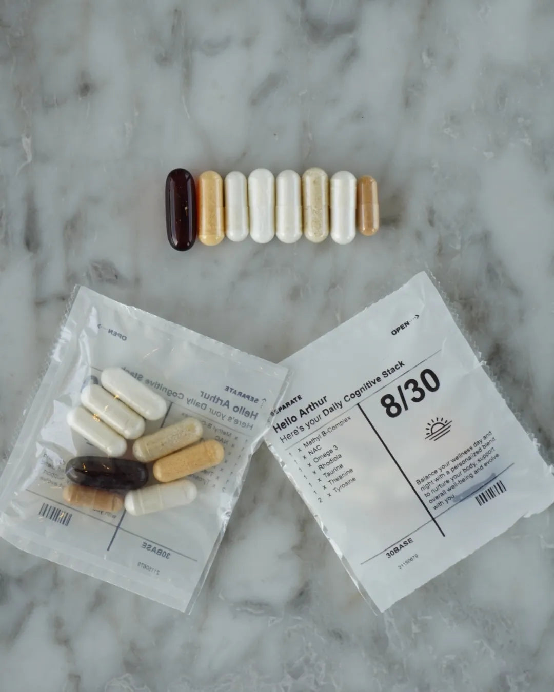 The eight capsules of one daily sachet lined up in daylight, showing the softgel and the seven capsules
